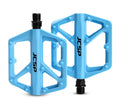 Blue nylon platform bicycle pedal pair on white