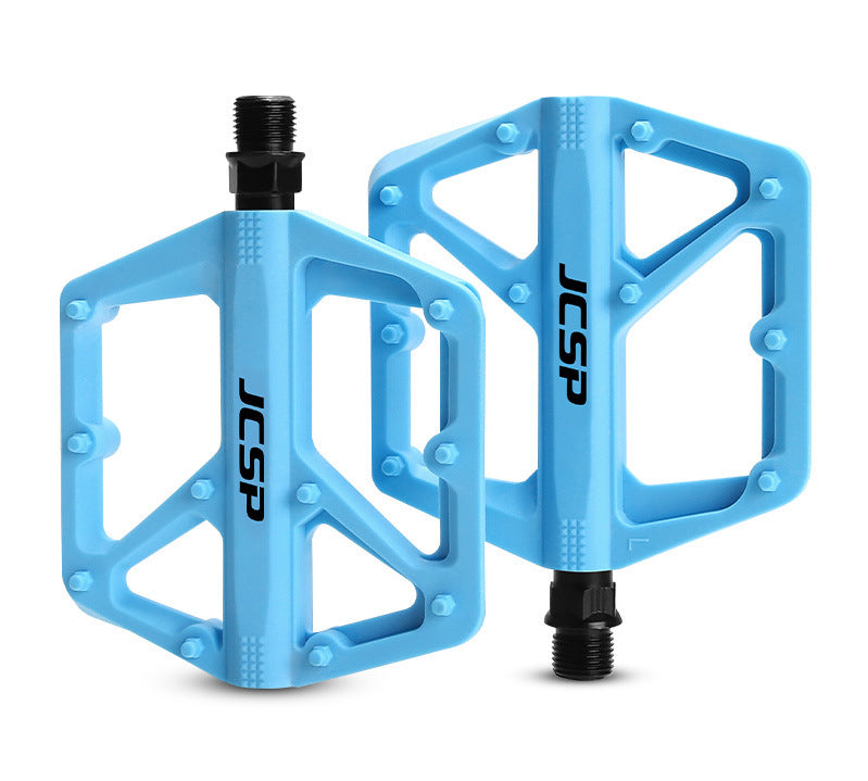 Blue nylon platform bicycle pedal pair on white