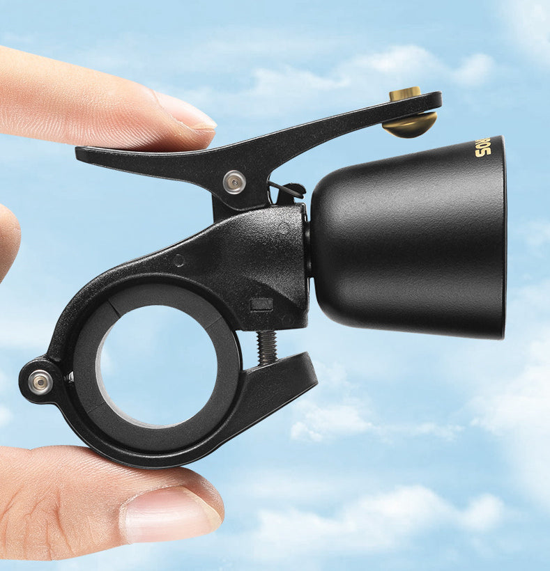 Thumb pressing the lever of the black bicycle bell