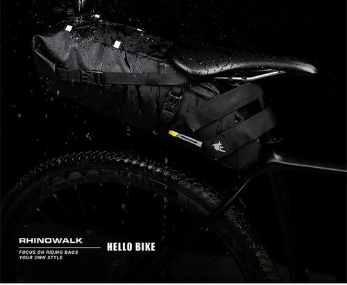 Black saddle tail bag shown during a water-exposure demonstration