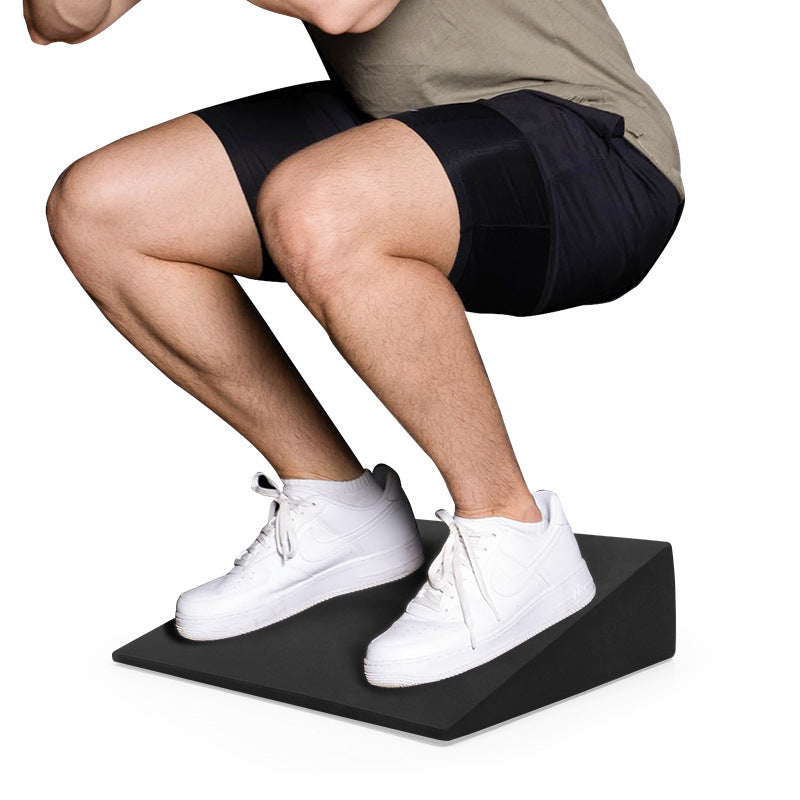 Large black EVA exercise wedge used for squat-position training