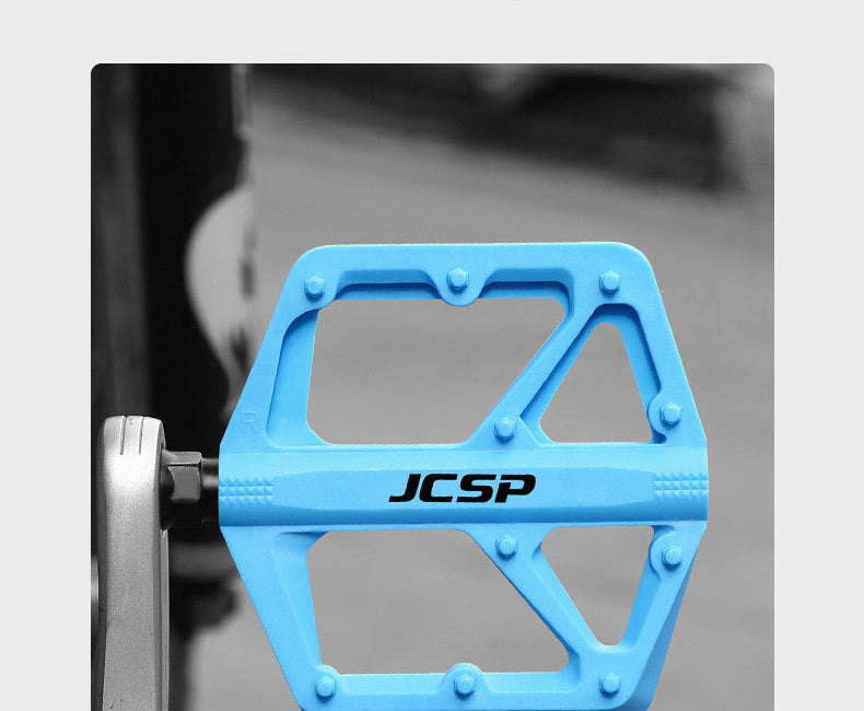 Blue nylon platform bicycle pedal installed on a crank