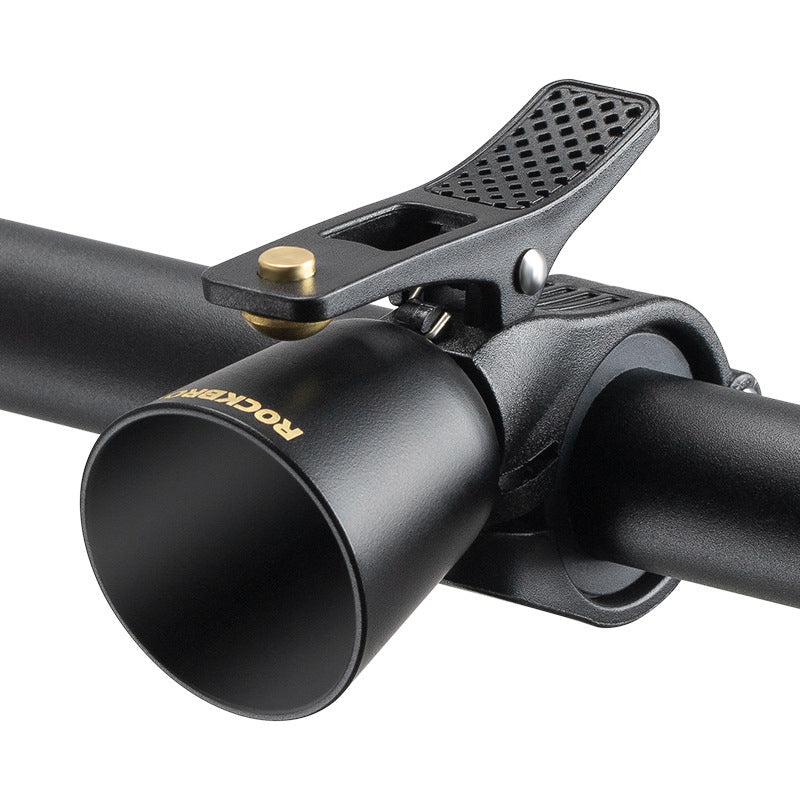 Black compact bicycle bell installed on a handlebar