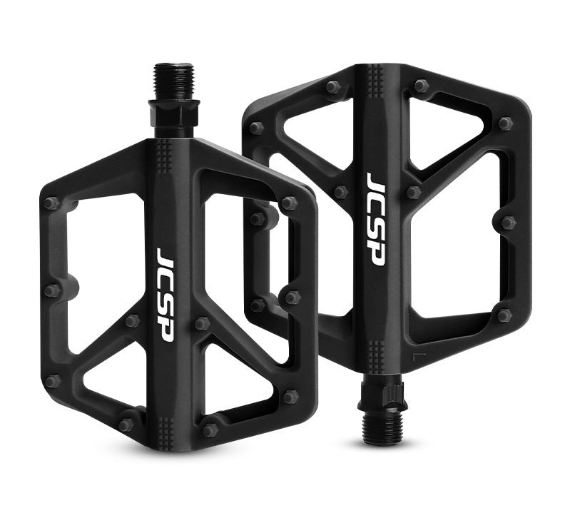 Black nylon platform bicycle pedal pair on white