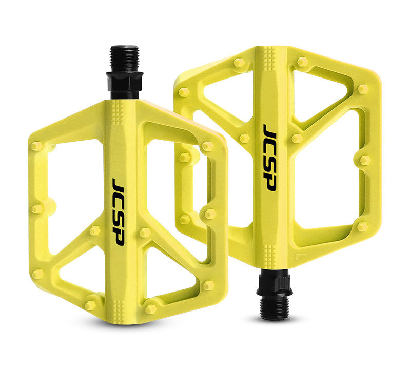 Yellow nylon platform bicycle pedal pair on white